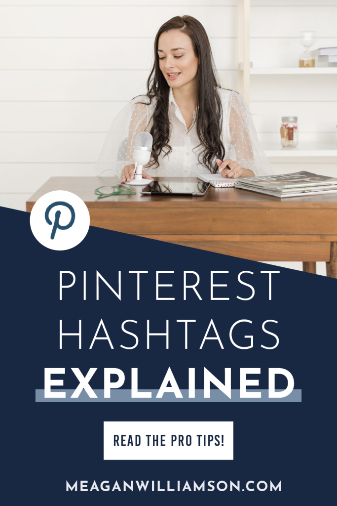Image of a woman at a desk with a microphone, surrounded by notebooks and magazines. Text overlay reads "Pinterest Hashtags Explained." Professional tone.